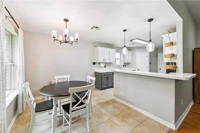 kitchen featuring light countertops, visible vents, and decorative light fixtures