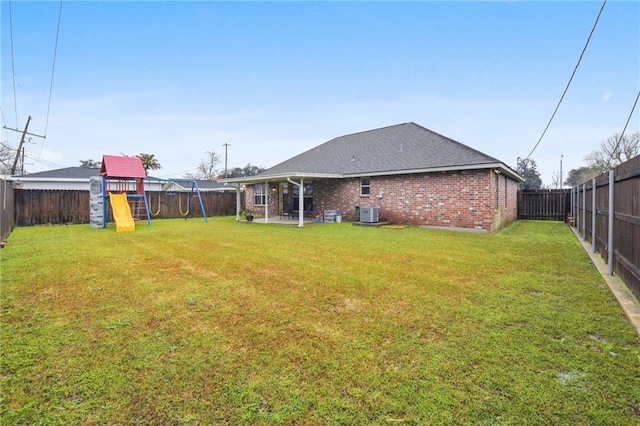 view of yard featuring a playground and a fenced backyard