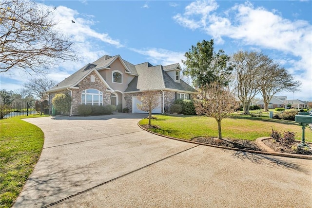 view of front of property with a garage, fence, concrete driveway, stone siding, and a front lawn