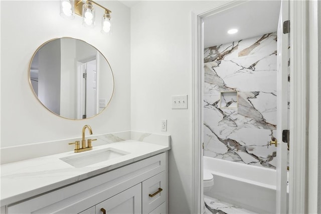 bathroom featuring toilet, marble finish floor, shower / tub combination, and vanity