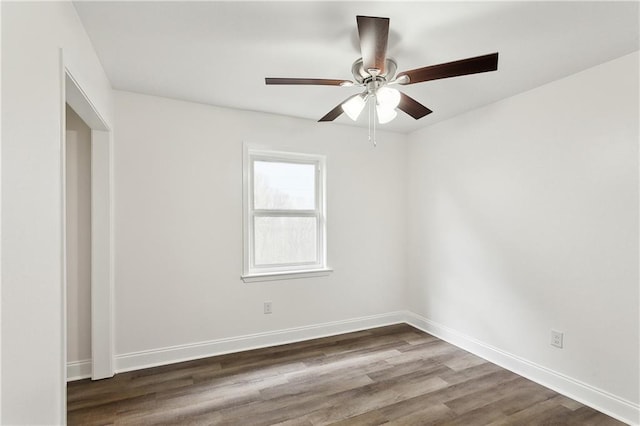 unfurnished room with dark wood finished floors, baseboards, and ceiling fan