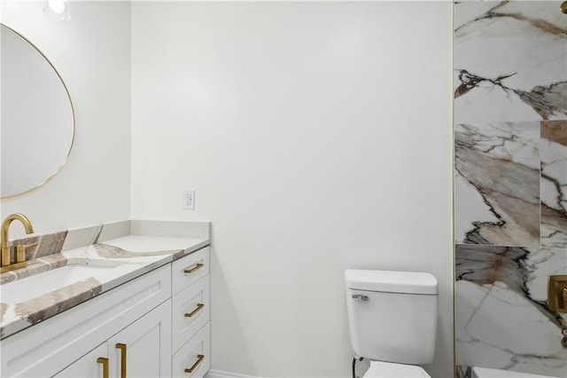 bathroom with toilet and vanity