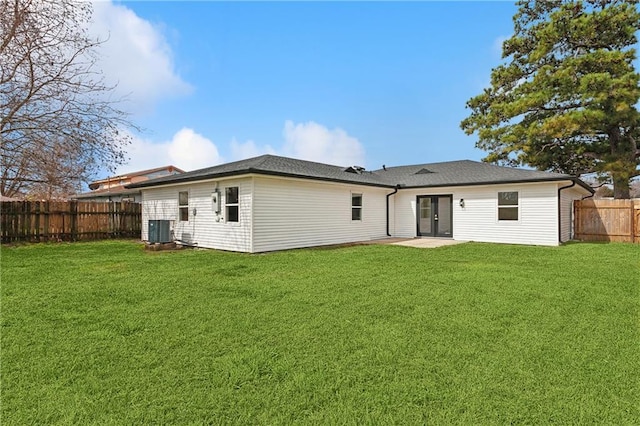 back of house featuring a patio area, a fenced backyard, cooling unit, and a yard