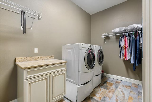 278 Lakeview Dr, Slidell, LA 70458 - laundry area featuring stone finish flooring, washing machine and dryer, cabinet space, and baseboards