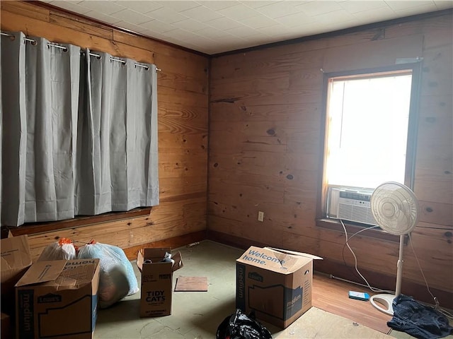 empty room with light wood-type flooring and wooden walls