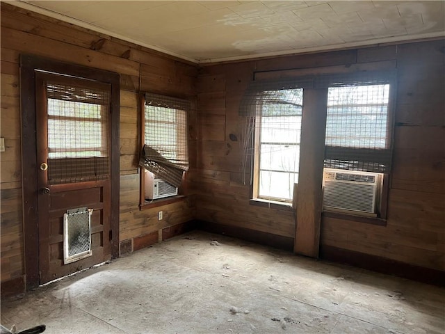 empty room featuring cooling unit and wooden walls