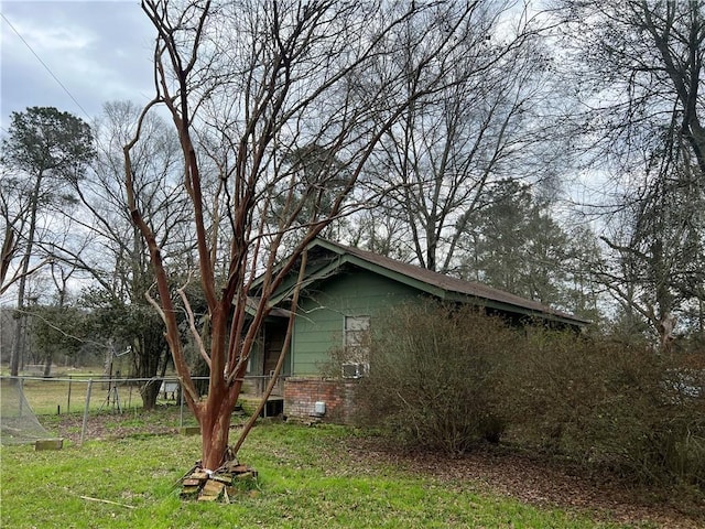 view of home's exterior with a yard, crawl space, and fence