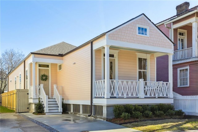 view of front of home with a shingled roof and a porch