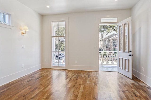 entryway featuring baseboards and wood finished floors