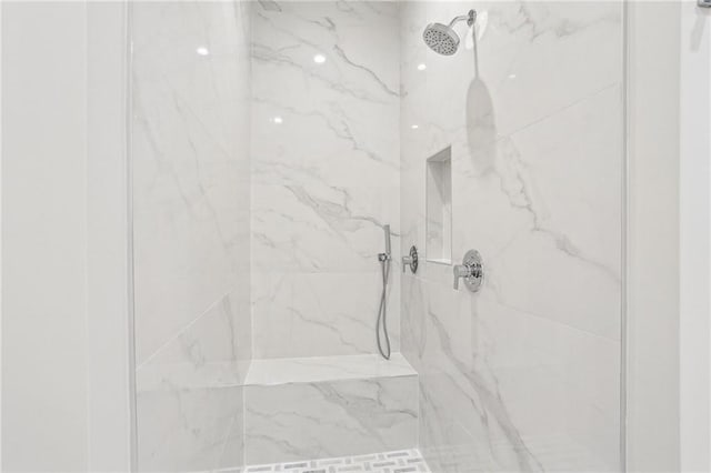 full bathroom with a marble finish shower