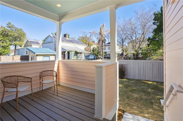 deck with a residential view and fence