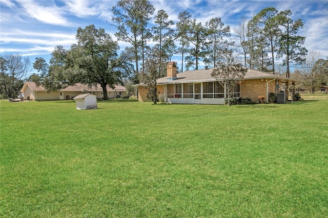 view of yard featuring a sunroom and cooling unit