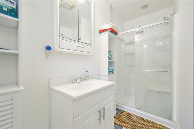 full bath with a stall shower and vanity