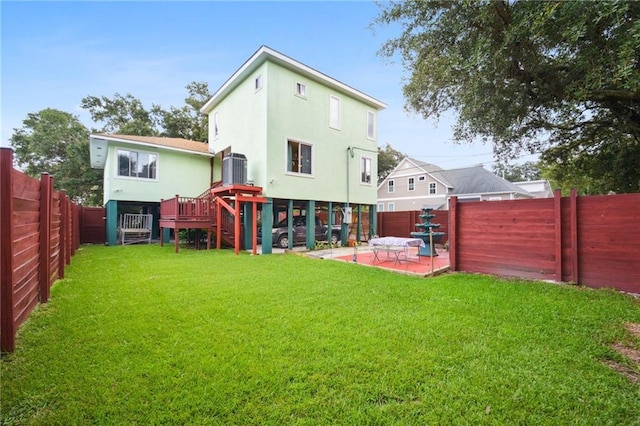 back of house featuring a patio area, a fenced backyard, a lawn, and stucco siding