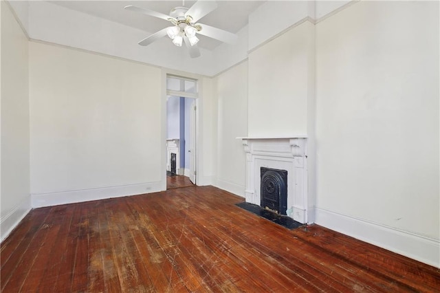 unfurnished living room featuring hardwood / wood-style floors, a fireplace with flush hearth, baseboards, and ceiling fan