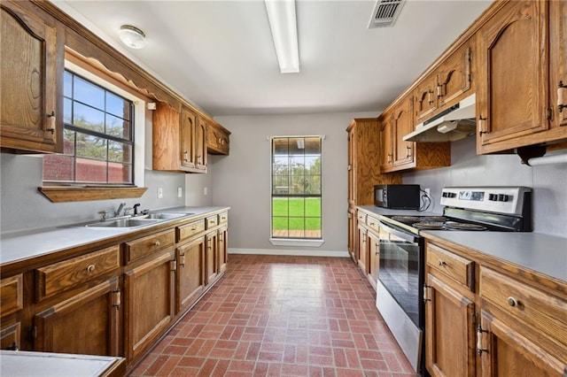 16685 Meissner Rd, Springfield, LA 70462 - kitchen with baseboards, under cabinet range hood, electric stove, a sink, and black microwave