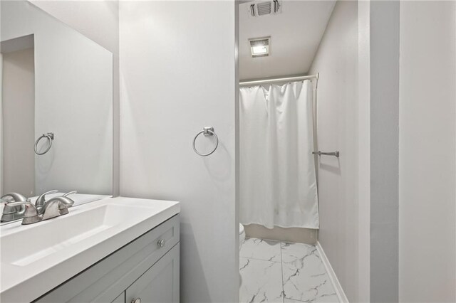 16685 Meissner Rd, Springfield, LA 70462 - full bathroom featuring visible vents, a shower with shower curtain, baseboards, marble finish floor, and vanity