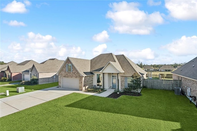 view of front of property featuring concrete driveway, fence, a garage, a residential view, and a front lawn