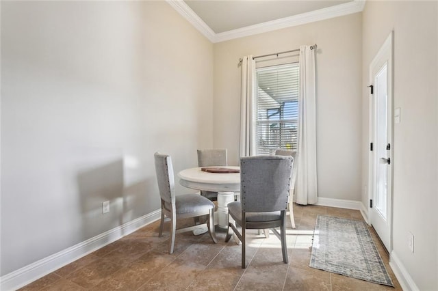 dining space featuring ornamental molding and baseboards