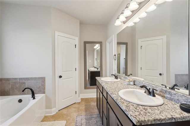 bathroom with double vanity, a sink, and a bath