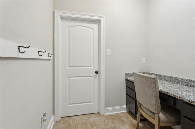 office area featuring baseboards and light tile patterned floors