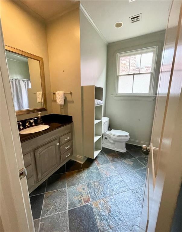 312 W Robert E Lee Blvd, New Orleans, LA 70124 - full bathroom with stone tile flooring, toilet, baseboards, visible vents, and vanity