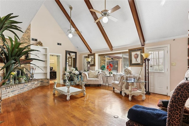 living area with a ceiling fan, wood finished floors, visible vents, high vaulted ceiling, and beam ceiling