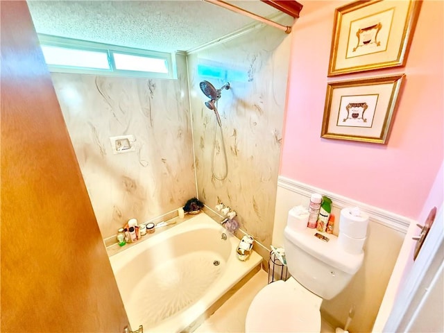 full bathroom with a textured ceiling, a bathtub, and toilet