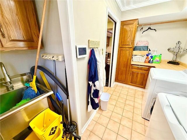 laundry area with cabinet space, separate washer and dryer, light tile patterned flooring, and ornamental molding