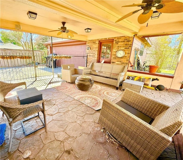 sunroom featuring a ceiling fan