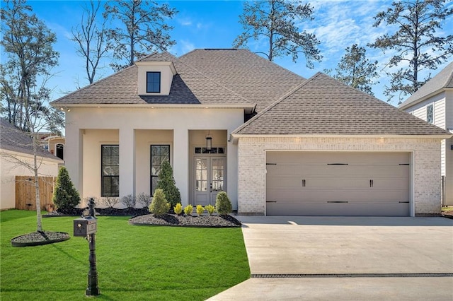 french country home with a garage, driveway, french doors, a front yard, and brick siding