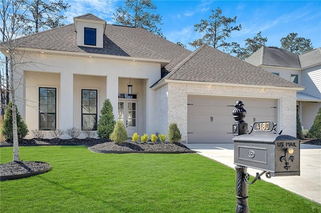 view of front facade featuring driveway, a garage, roof with shingles, a front lawn, and brick siding