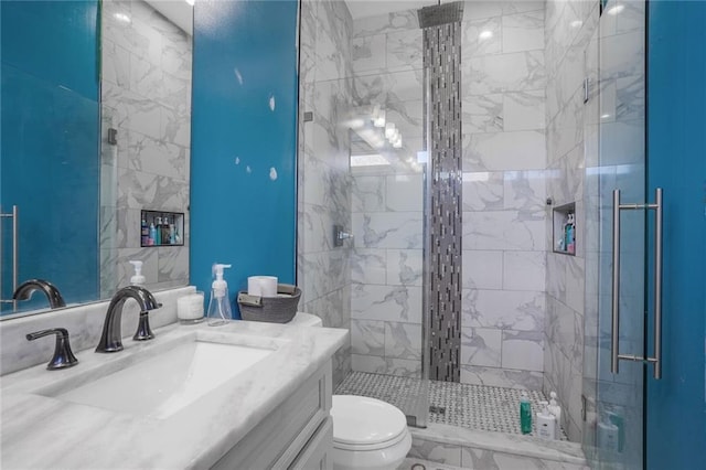 full bath with a shower stall, toilet, and vanity