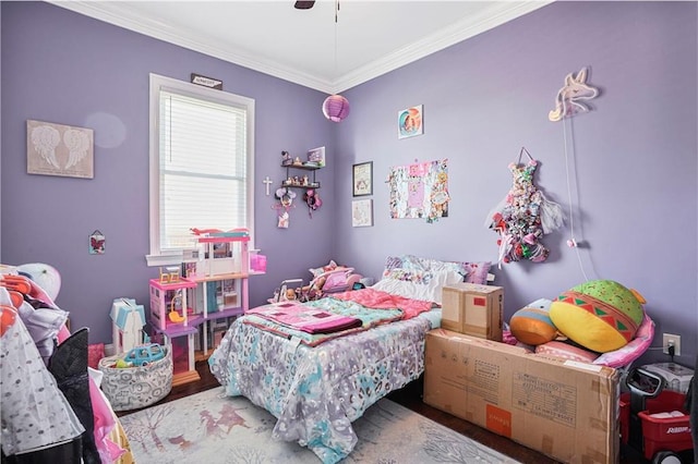 bedroom featuring ceiling fan, crown molding, and wood finished floors