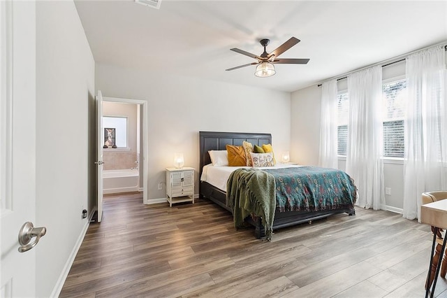 bedroom featuring visible vents, wood finished floors, a ceiling fan, and baseboards