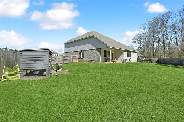 exterior space featuring an outdoor structure, a fenced backyard, and exterior structure