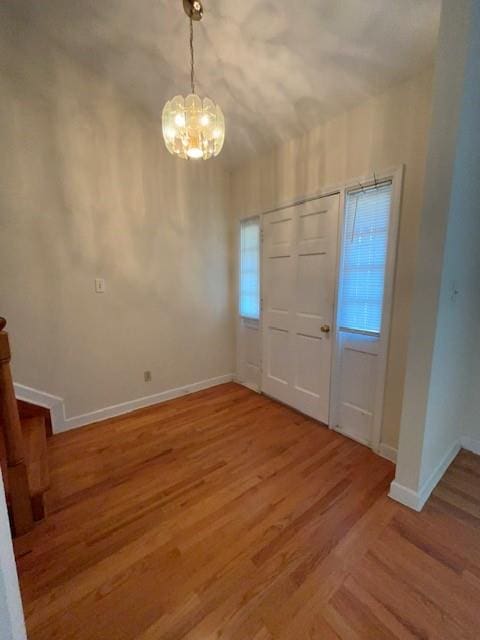 entryway with light wood-style flooring and baseboards