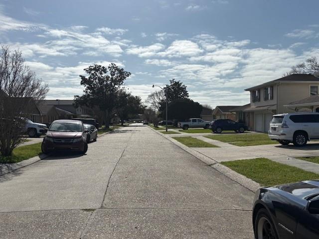 view of street with a residential view and street lights