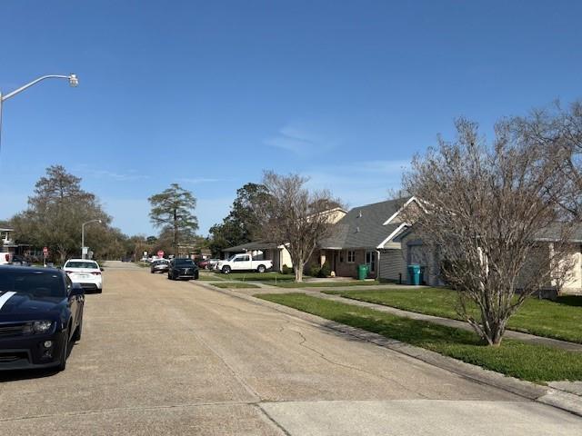 view of street with curbs, sidewalks, and street lights