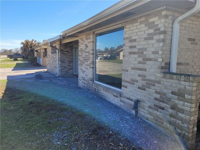 view of property exterior featuring brick siding