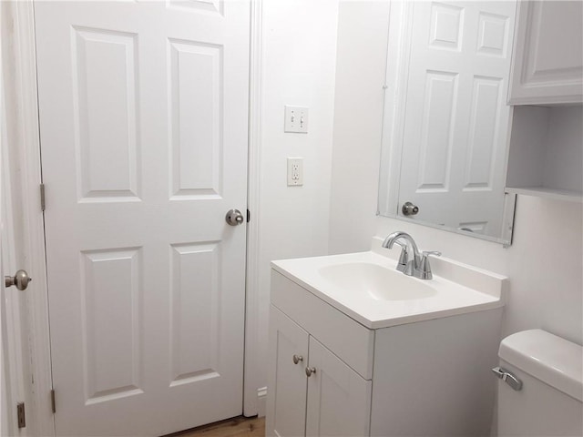 bathroom with toilet and vanity