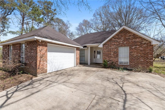 ranch-style home with concrete driveway, brick siding, and an attached garage