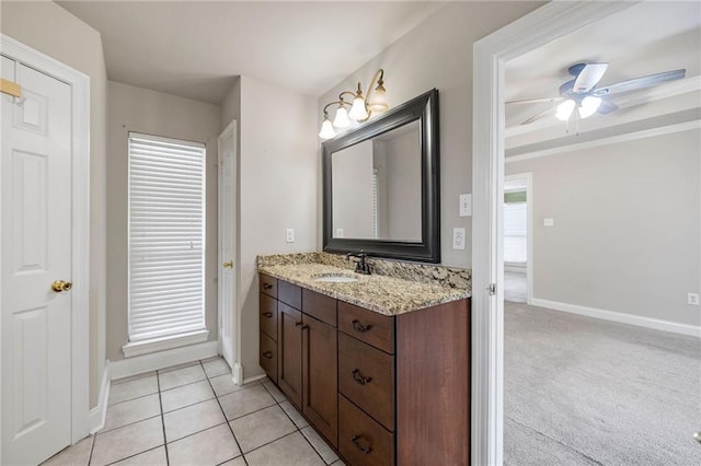 bathroom featuring plenty of natural light, baseboards, ceiling fan, tile patterned floors, and vanity