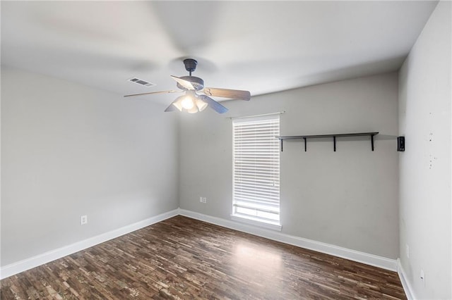 spare room with baseboards, visible vents, ceiling fan, and wood finished floors