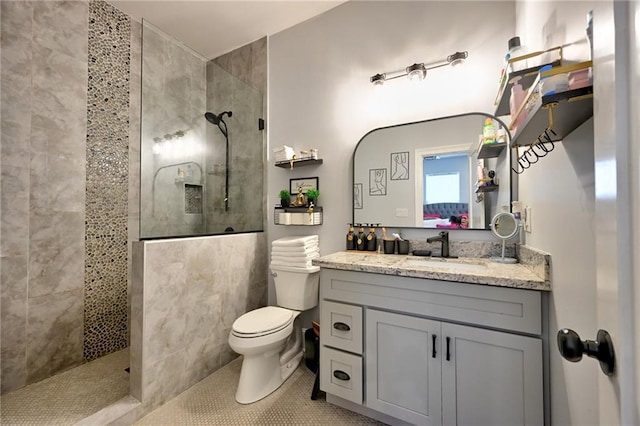 bathroom with tile patterned flooring, vanity, toilet, and walk in shower