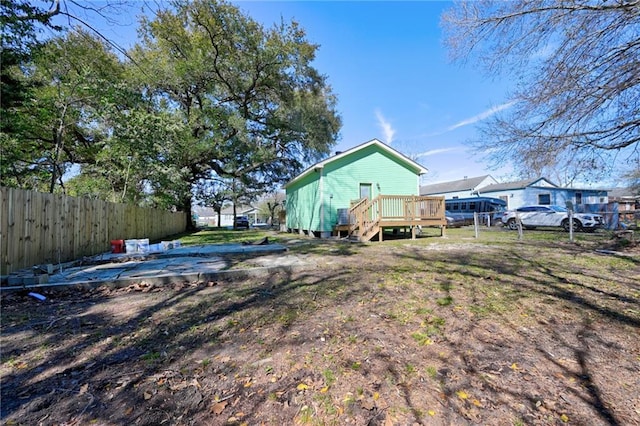 view of yard with fence and a wooden deck