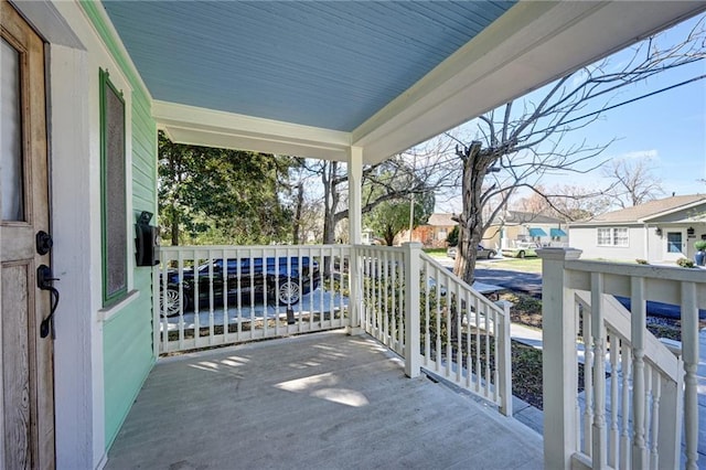 balcony with covered porch and a residential view