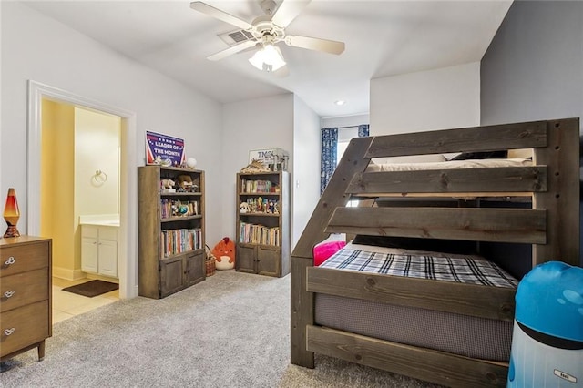 bedroom featuring carpet flooring, a ceiling fan, ensuite bathroom, and visible vents