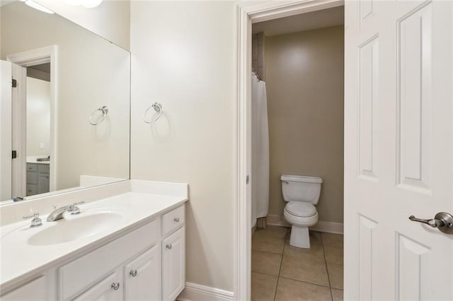 full bathroom featuring tile patterned flooring, toilet, vanity, and baseboards