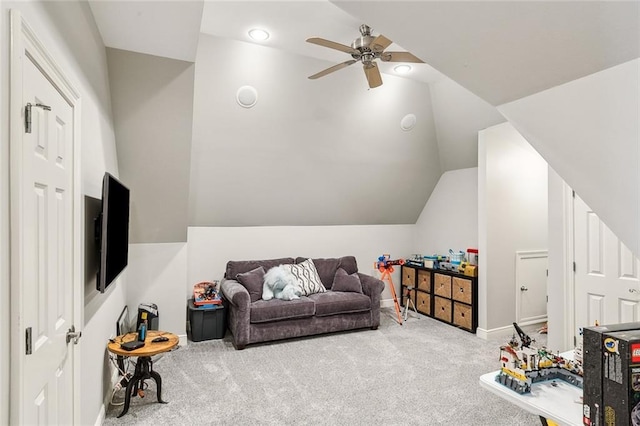 carpeted living area with baseboards, lofted ceiling, and ceiling fan